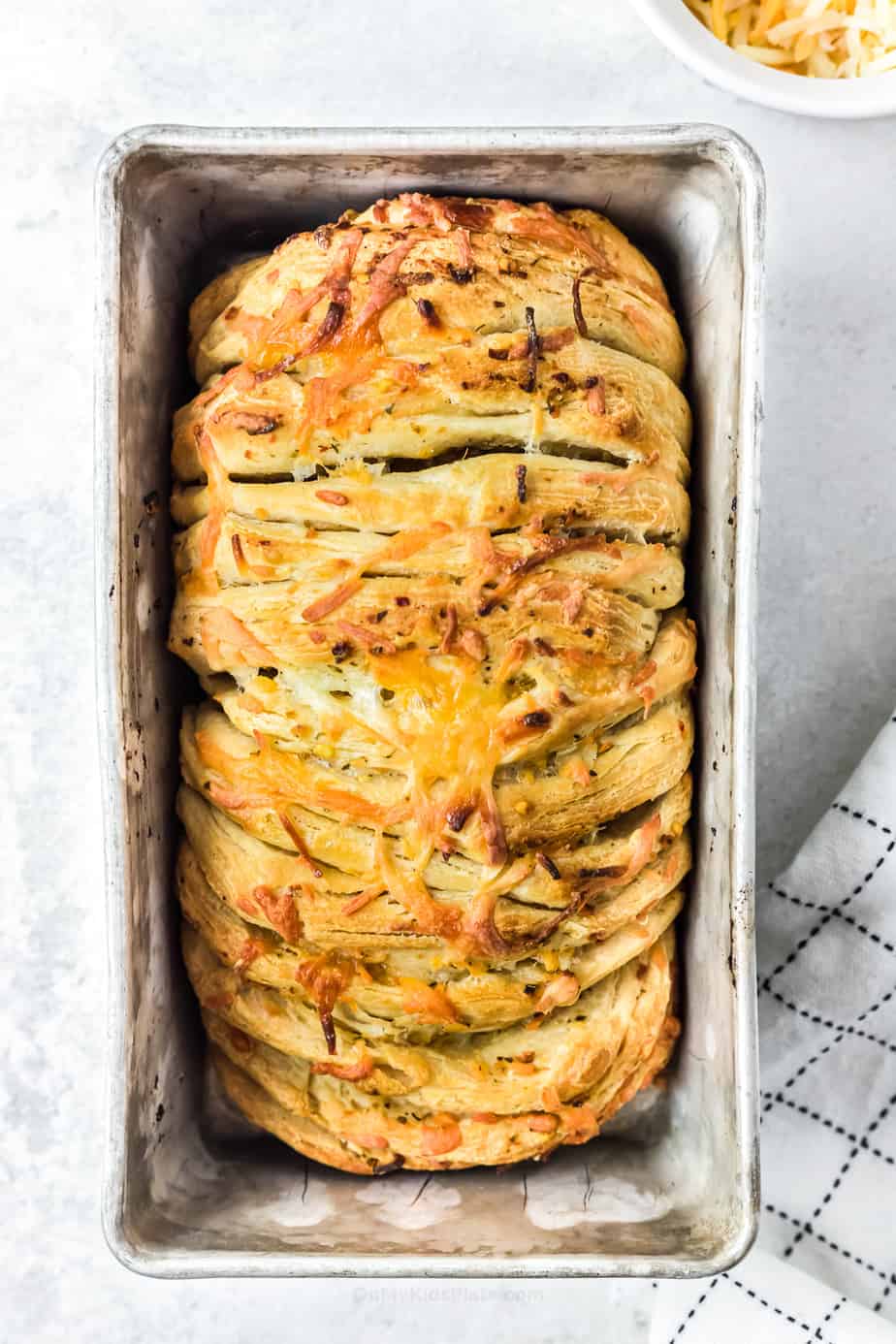 Baked pull apart cheesy bread in a pan from overhead