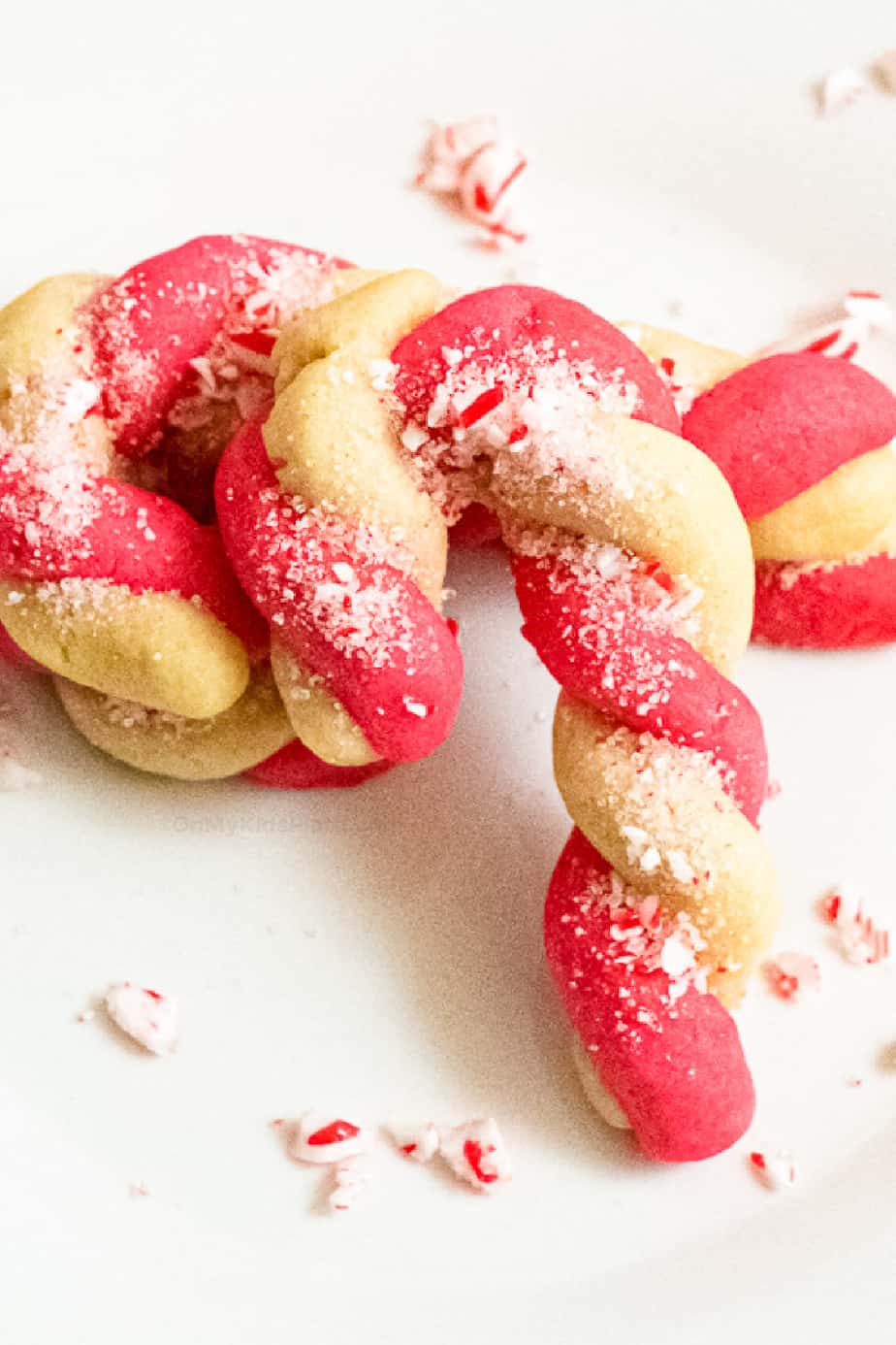Close up of candy cane cookie finished sprinkled with peppermint