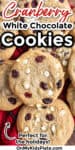 Close up of a platter of white chocolate chip and cranberry cookies with text title overlay