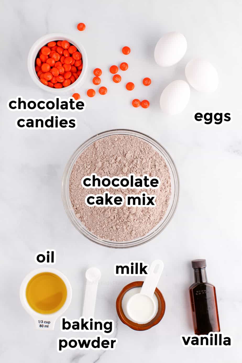 Ingredients in bowls from overhead labeled for chocolate cake mix cookies