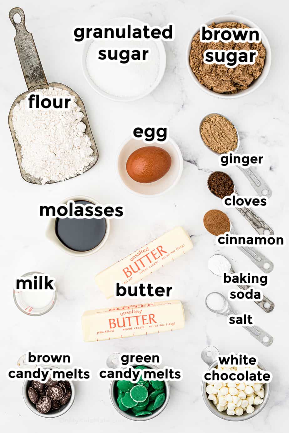 Ingredients for molasses ginger cookies in bowls overhead labeled