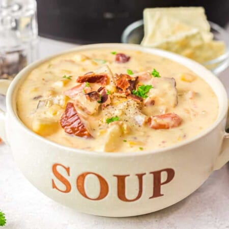 Close up image of potato soup in a bowl labeled soup with bacon on top