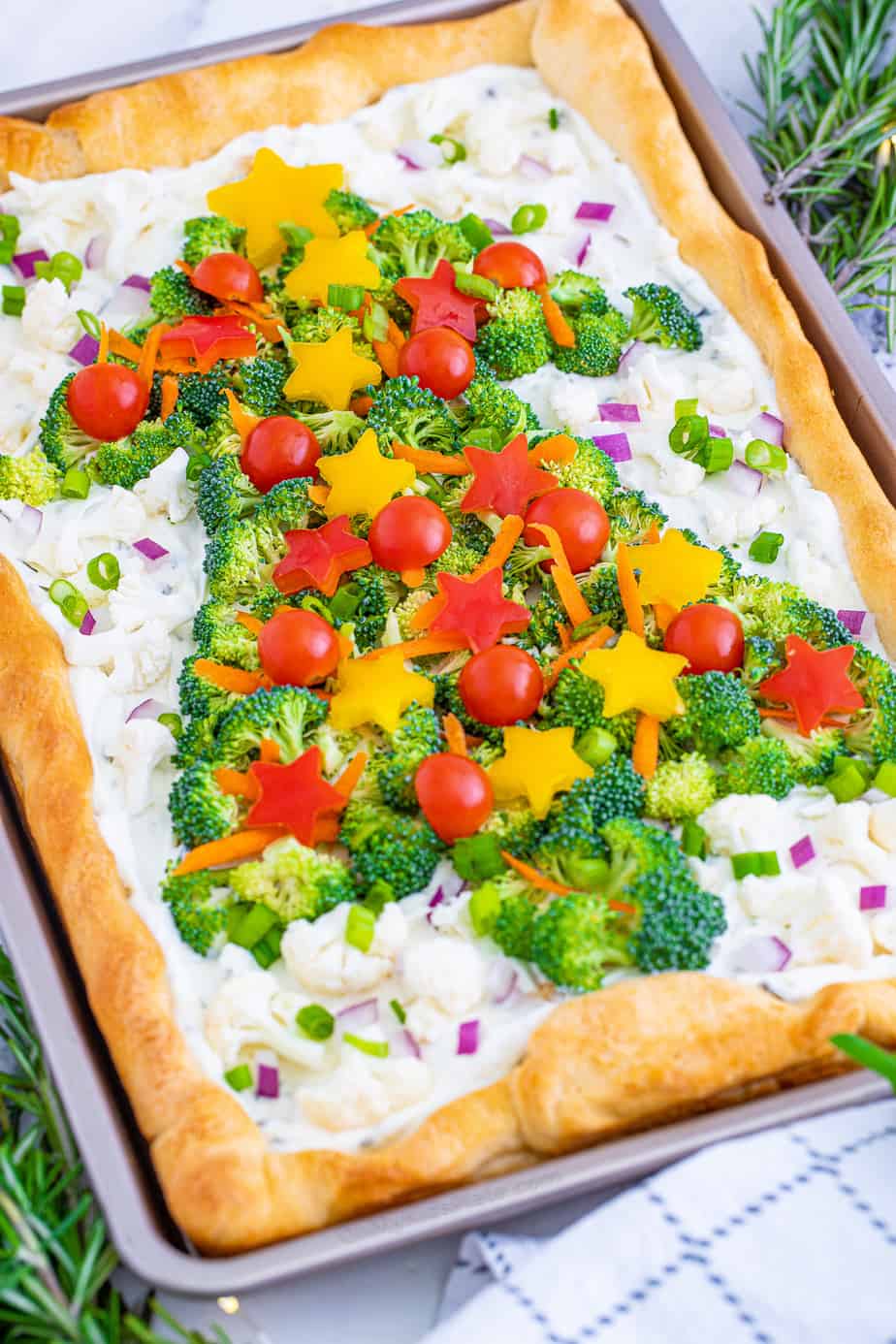 Veggie pizza appetizer on a pan decorated like a Christmas tree close up