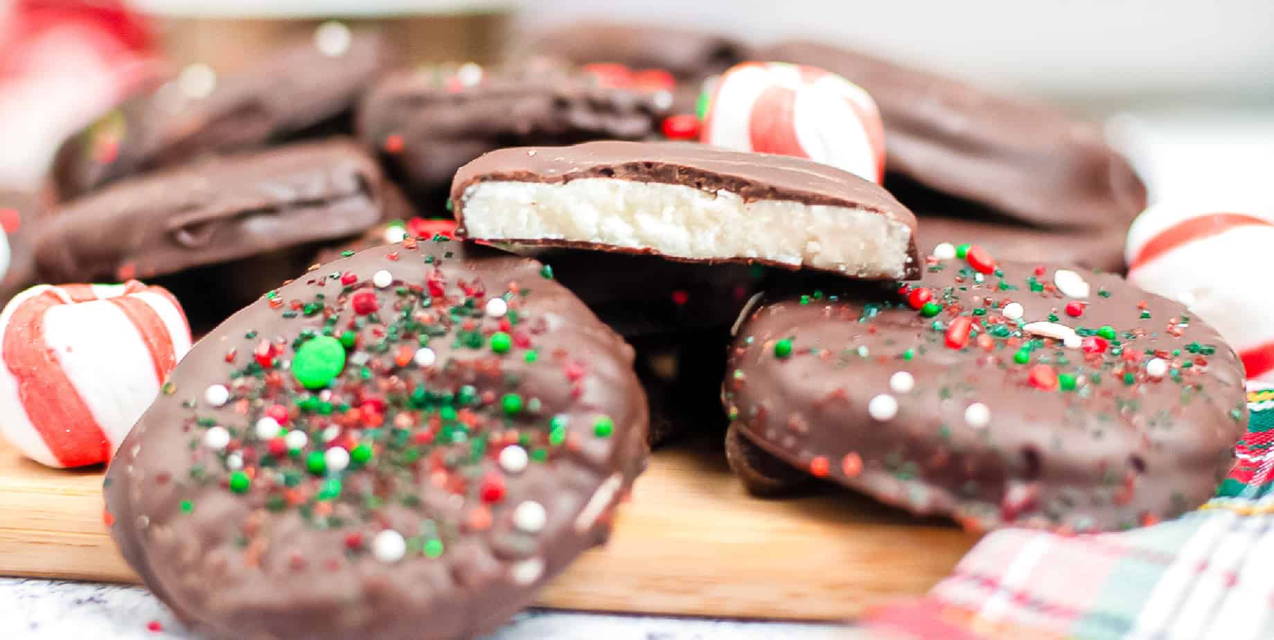 Several stacked peppermint patties on a cutting board close up. One peppermint patty you can see inside