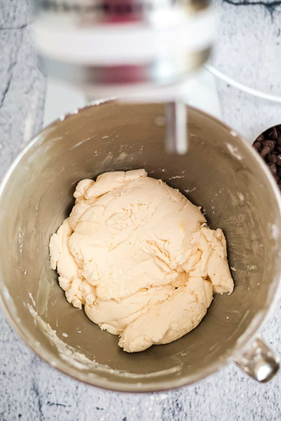 Dough mixed in the bowl of a stand mixer from overhead