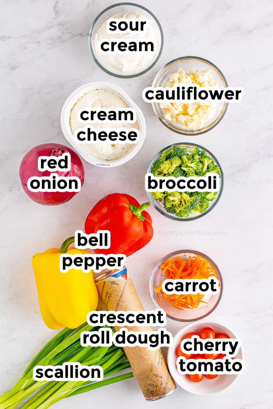 Ingredients for veggie pizza in bowls with labels from overhead