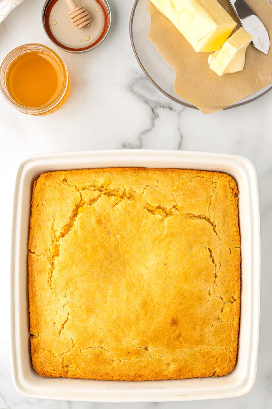 Cornbread baked in a square pan from overhead.