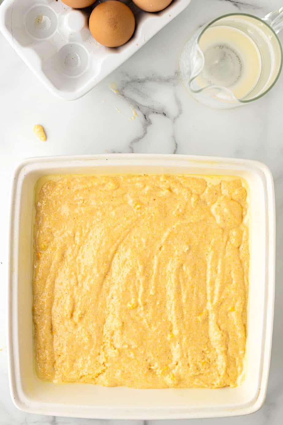 Cornbread batter in a square pan from overhead