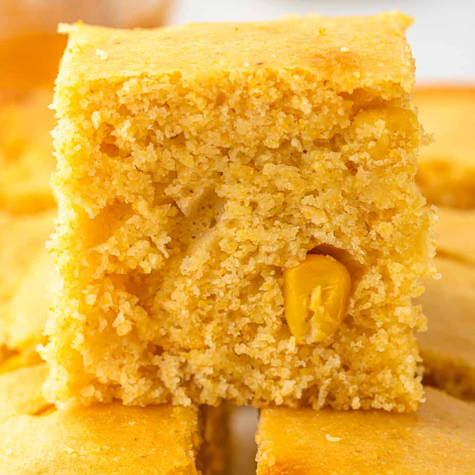 Close up side view of cornbread stacked on other pieces