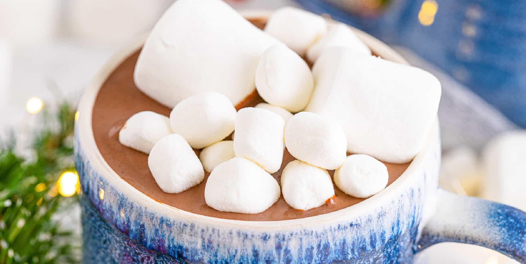 Top of a mug close up filled with hot chocolate and marshmallows