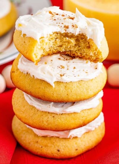 Frosted Eggnog Cookies Stacked with bite missing side.