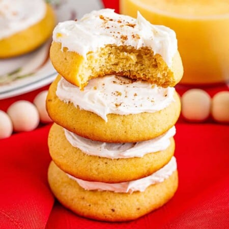 Frosted Eggnog Cookies Stacked with bite missing side.