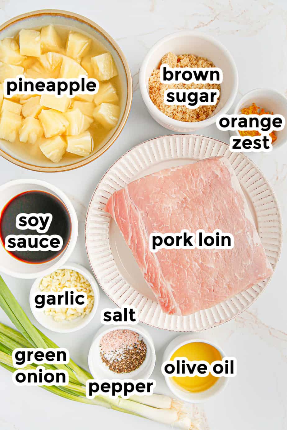 Ingredients in bowls with labels for pineapple pork loin