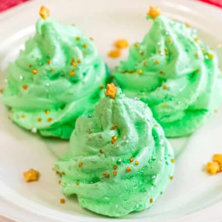 Square image of three green meringue cookies shaped like christmas trees