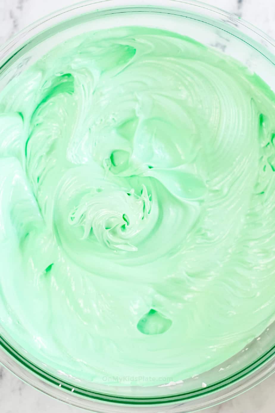Meringue in a bowl colored green with food coloring