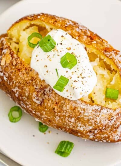 Close up overhead of a baked potato with sour cream
