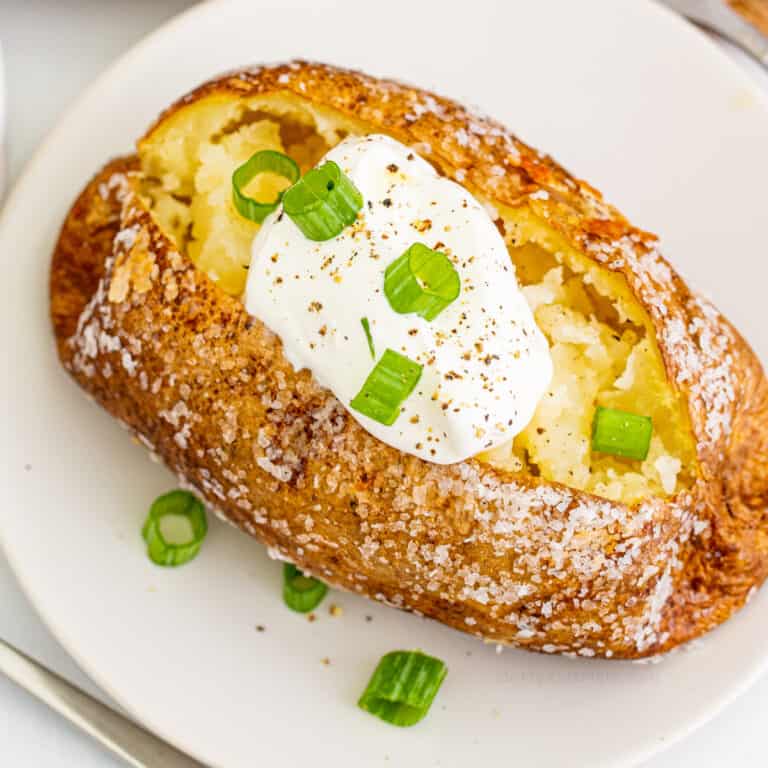 Close up overhead of a baked potato with sour cream