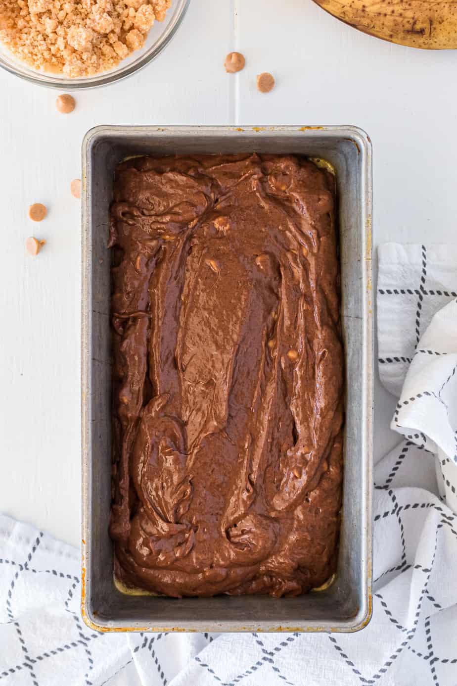 Raw chocolate batter in a loaf pan overhead