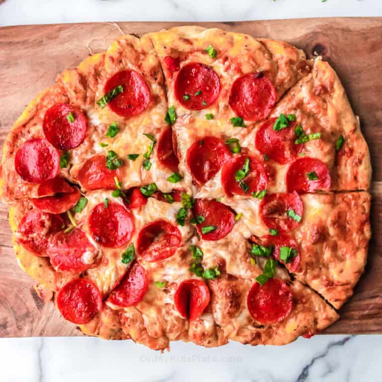 Close up of pepperoni pizza on a cutting board