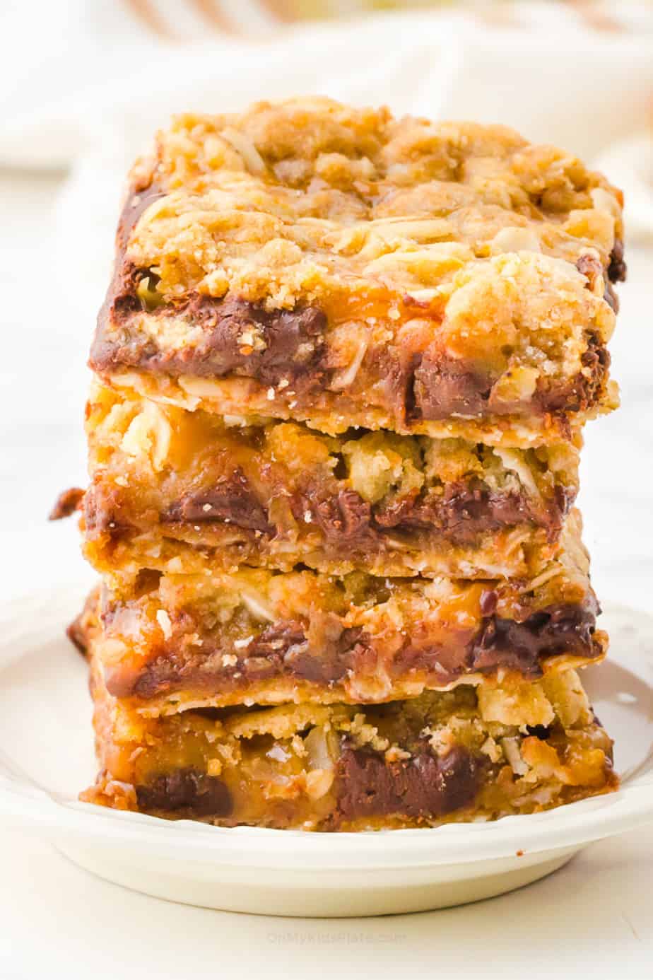 Stack four cookies high of carmelita bars on a plate from the side