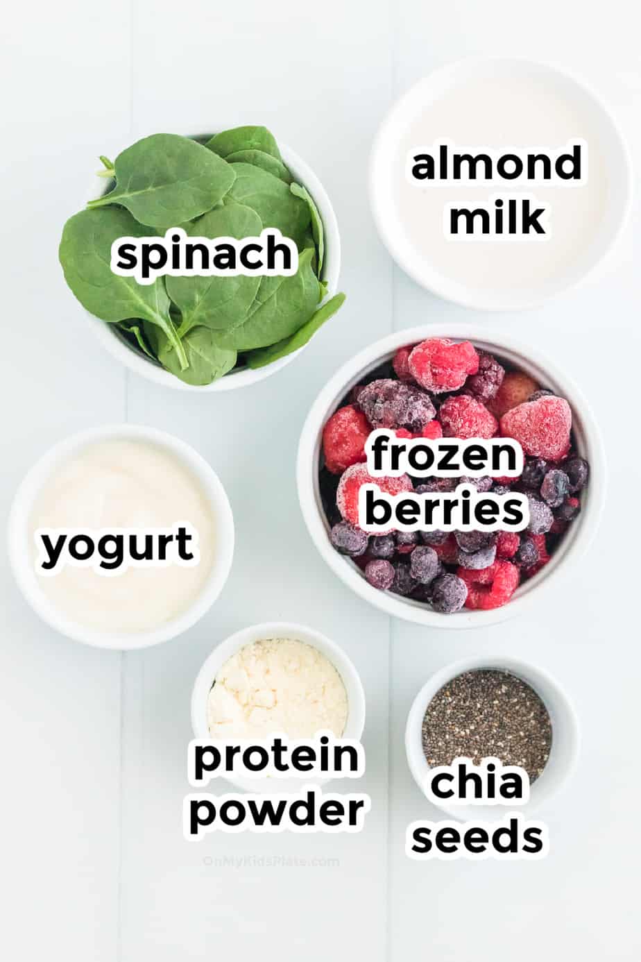 ingredients for berry smoothie in bowls with labels