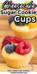 Close up of a sugar cookie cup full of cheesecake filling and topped with fruit with title text overlay