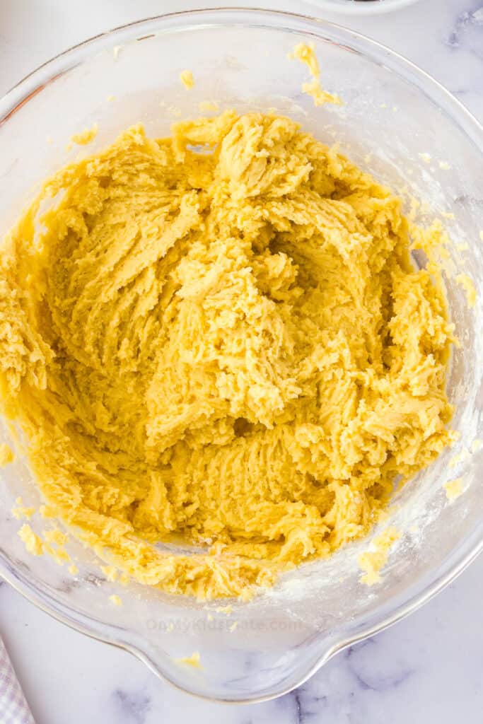 Mini egg cookie dough in a large mixing bowl from overhead