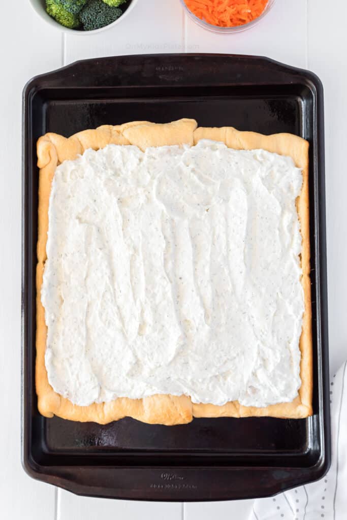 Flavored cream cheese spread onto crescent dough