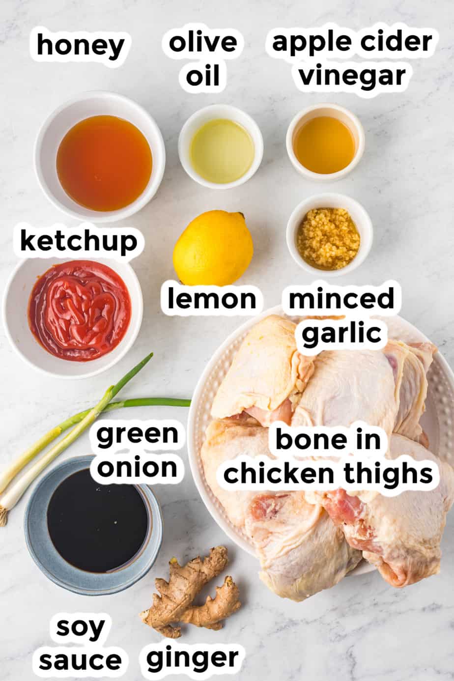 ingredients for honey garlic chicken thighs in bowls from overhead with labels