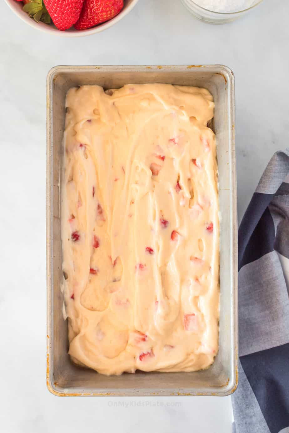 batter for strawberry bread in greased loaf pan from overhead