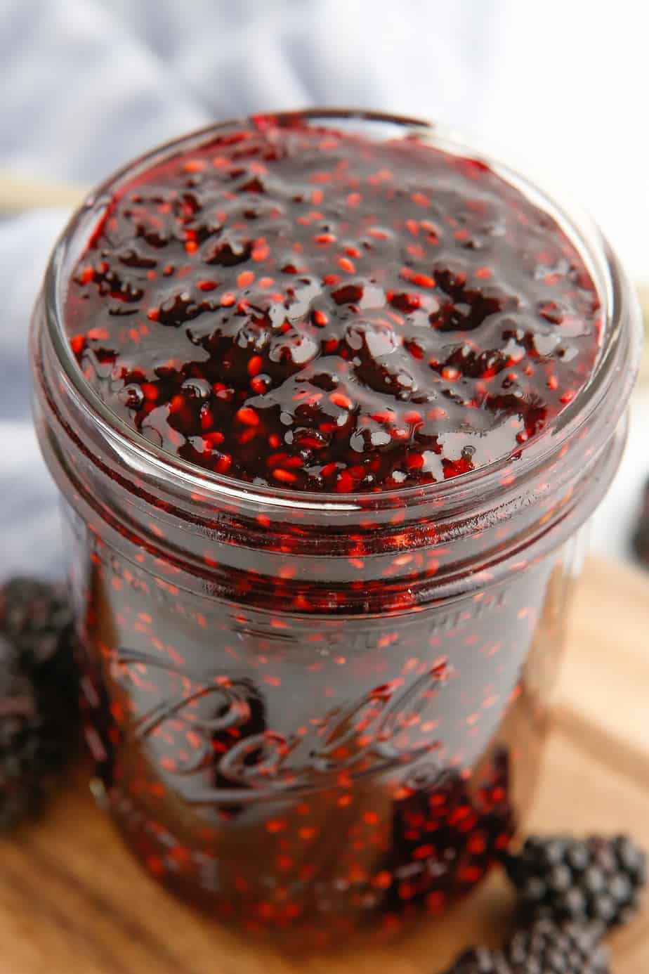 blackberry jam filling a canning jar open from overhead
