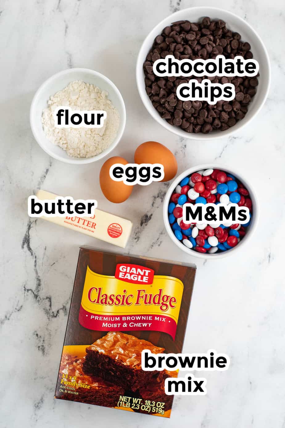 Ingredients for brownie mix cookies on the counter in bowls with labels from above.