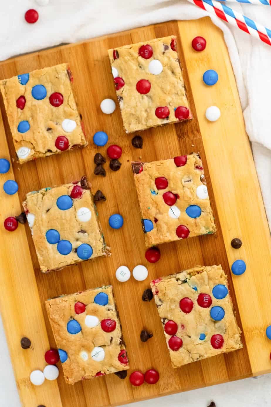 MM cookie bars on a board platter with red white and blue MMs scattered around the platter from above.