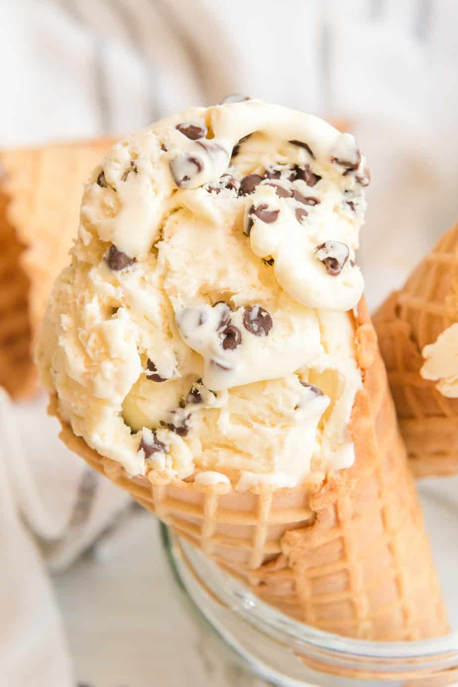 Chocolate chip ice cream in a cone close up.
