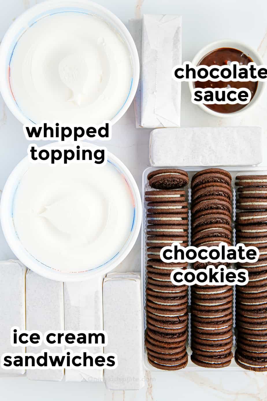 Ingredients for cookies and cream ice cream cake on a table from overhead with labels.