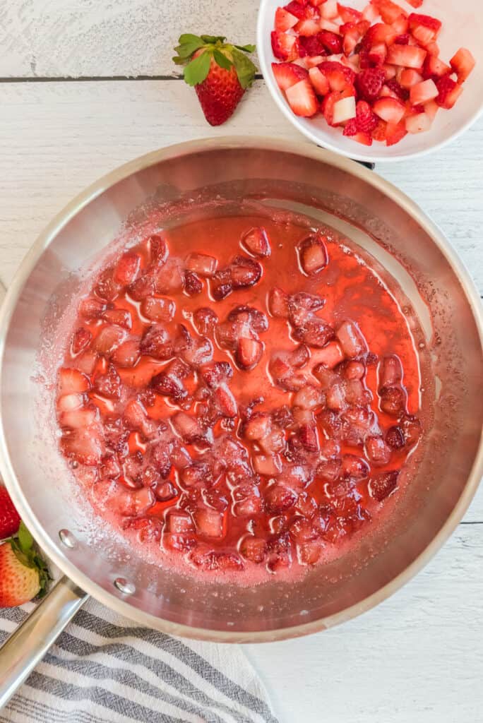Cooked strawberries in a pan for strawberry swirl ice cream