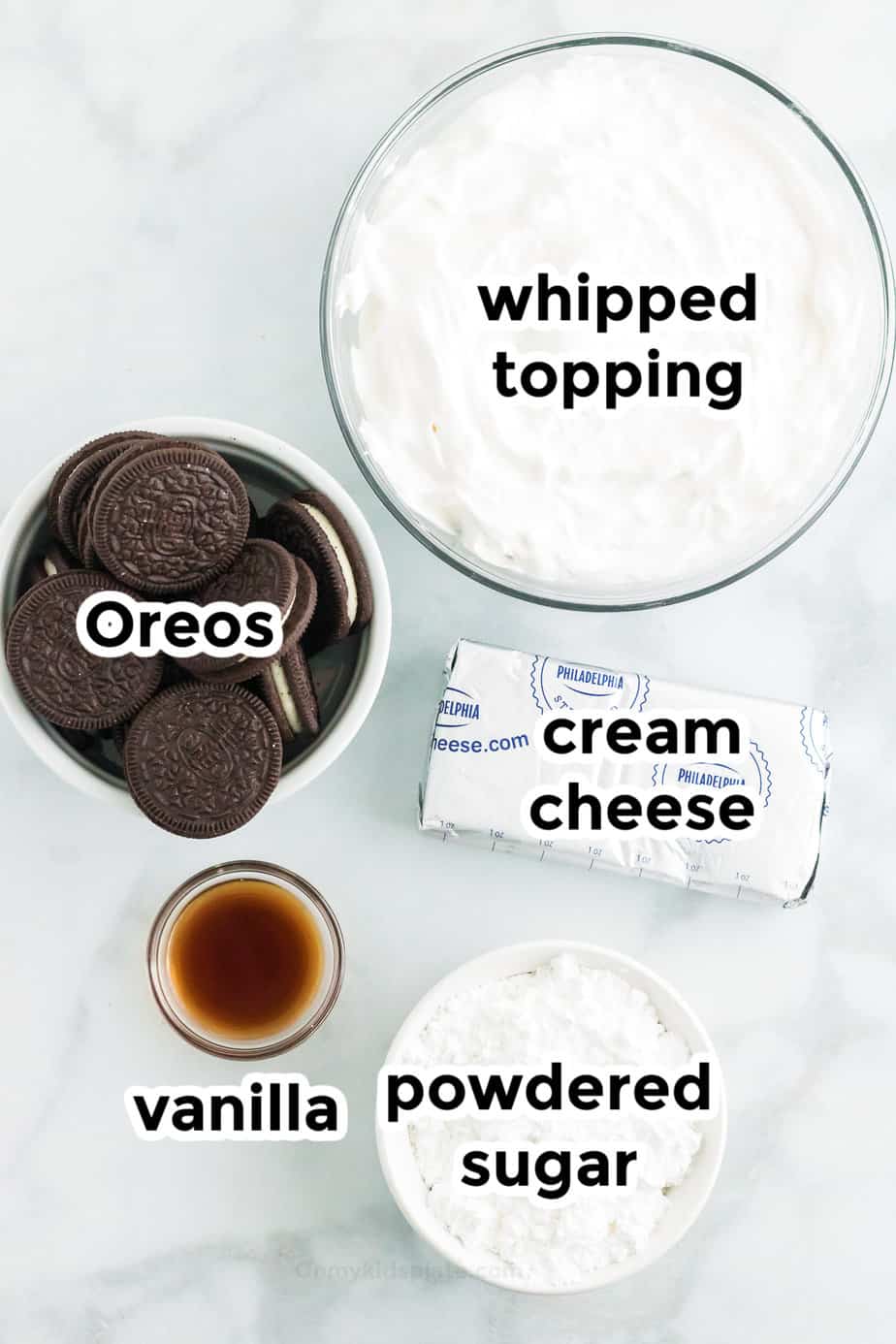 Ingredients for Oreo dip in bowls from overhead with labels.