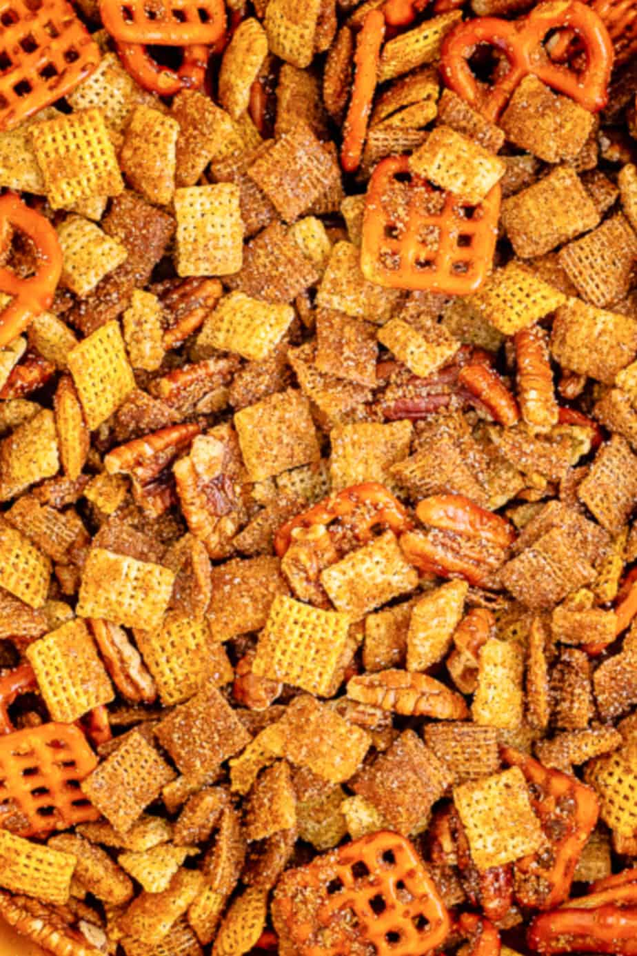 Cinnamon sugar chex mix close up with a mixture of chex cereals, pretzels, pecans and the crunch topping from overhead zoomed in.