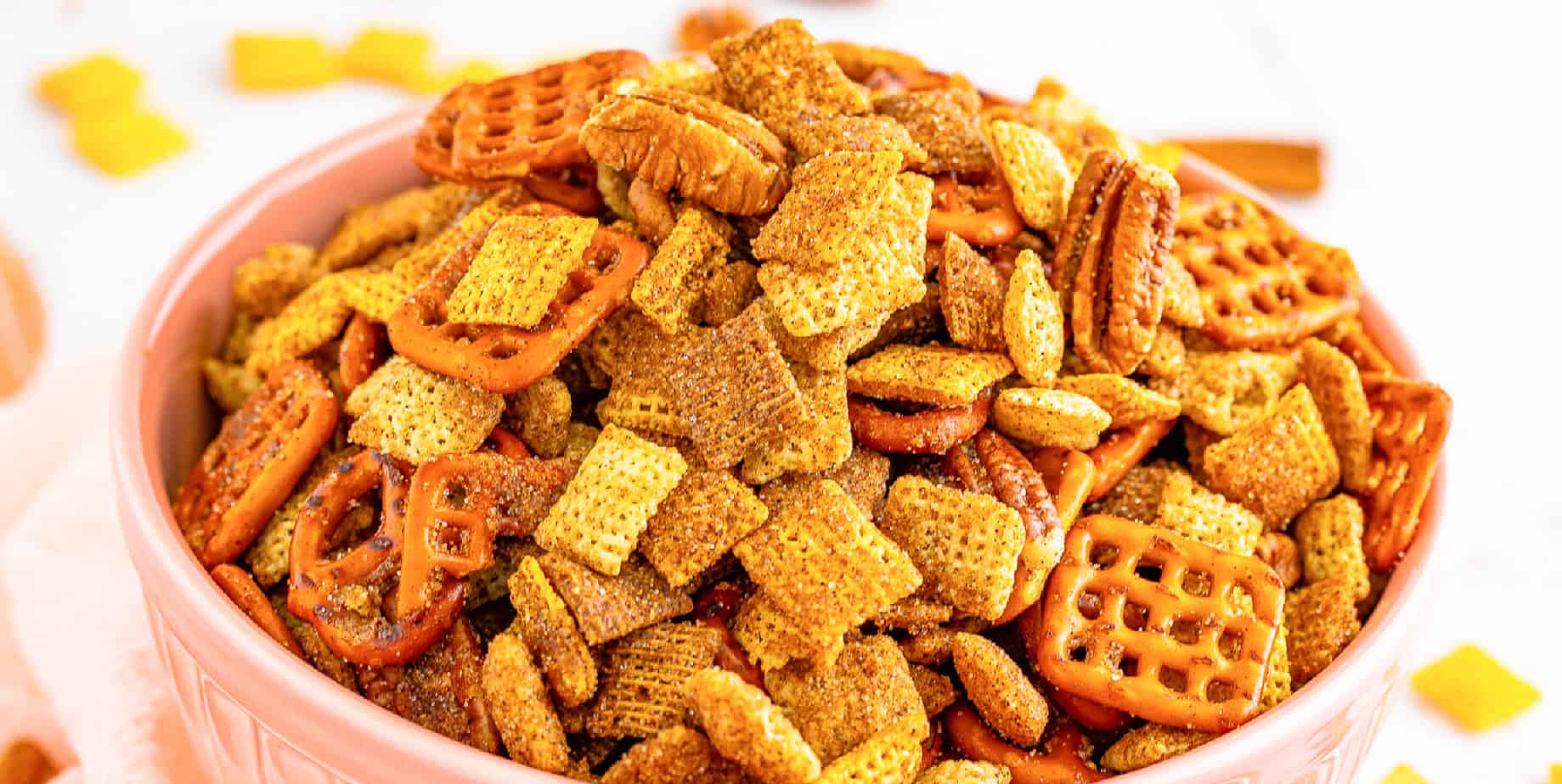 Cinnamon sugar chex mix in a pink bowl.