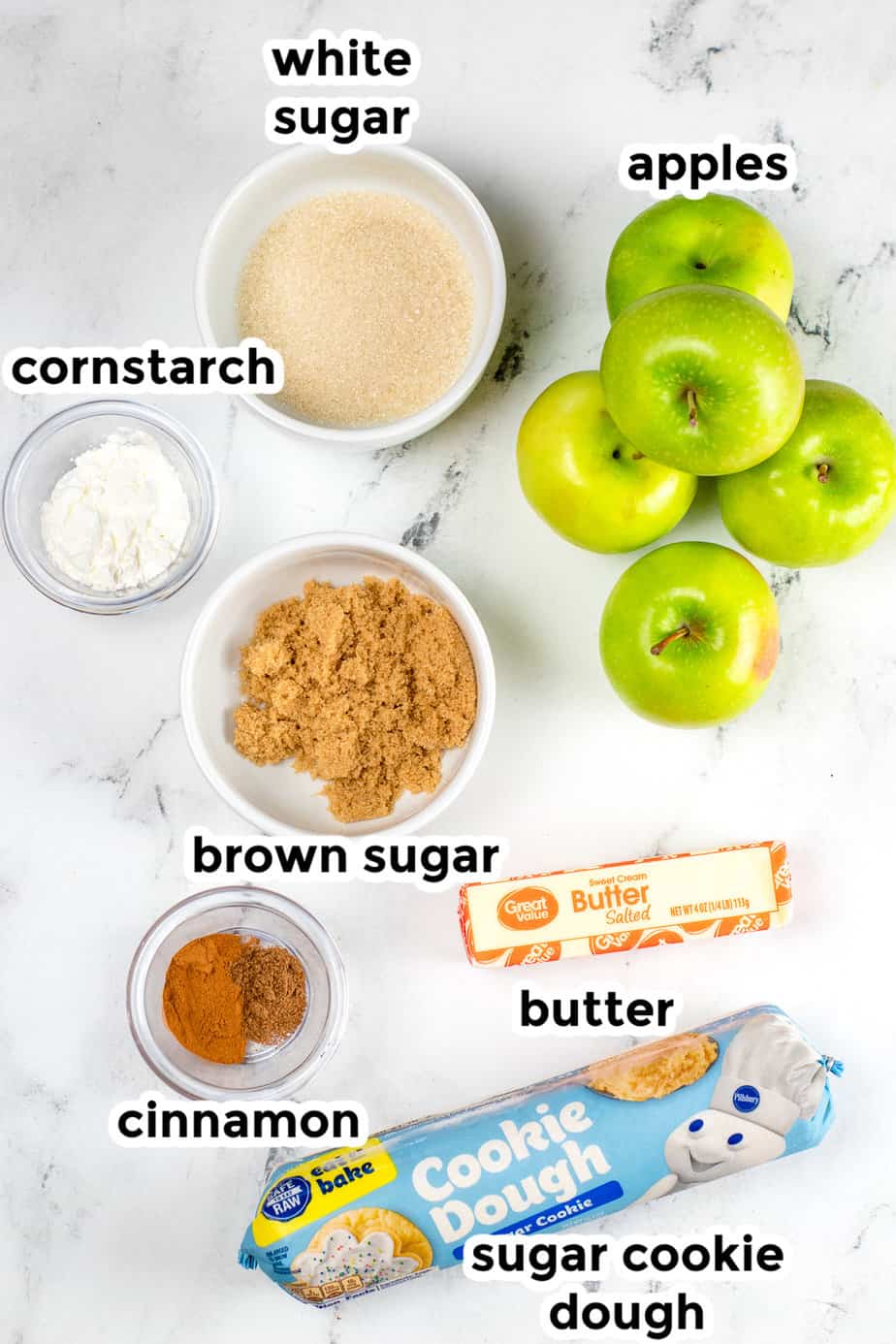 Ingredients for apple crisp cookie cups from overhead in bowls on a counter with text label overlay.