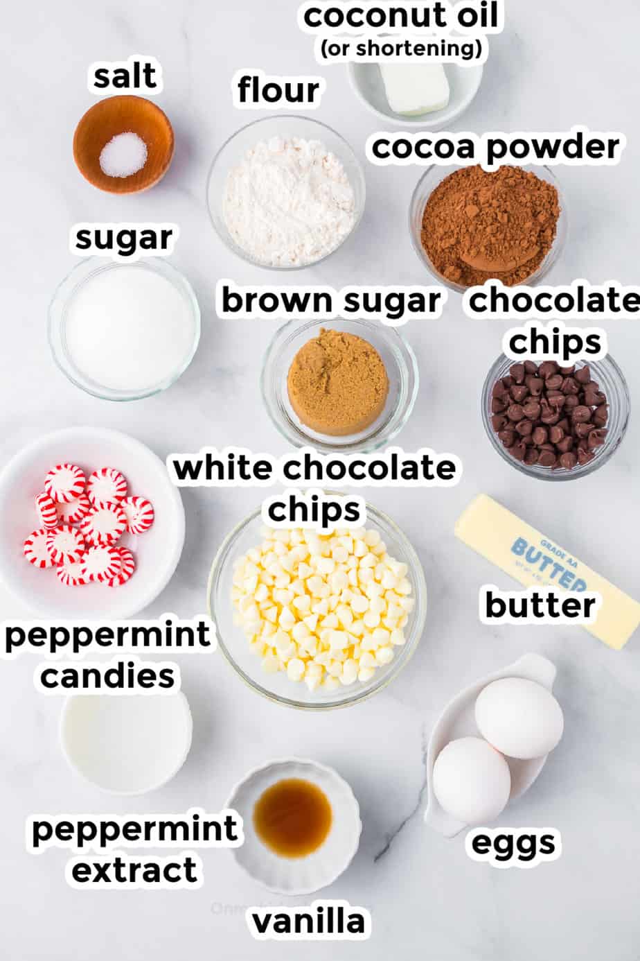 Ingredients for peppermint bark brownies on a counter in bowls with labels from above.