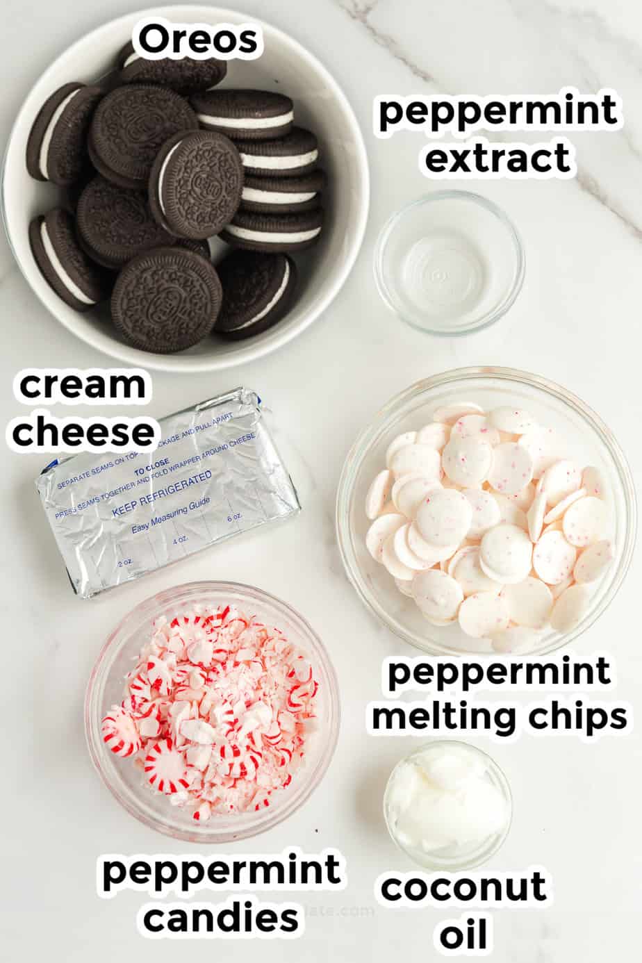 Ingredients for peppermint oreo cookie balls in bowls on a counter from overhead with labels.