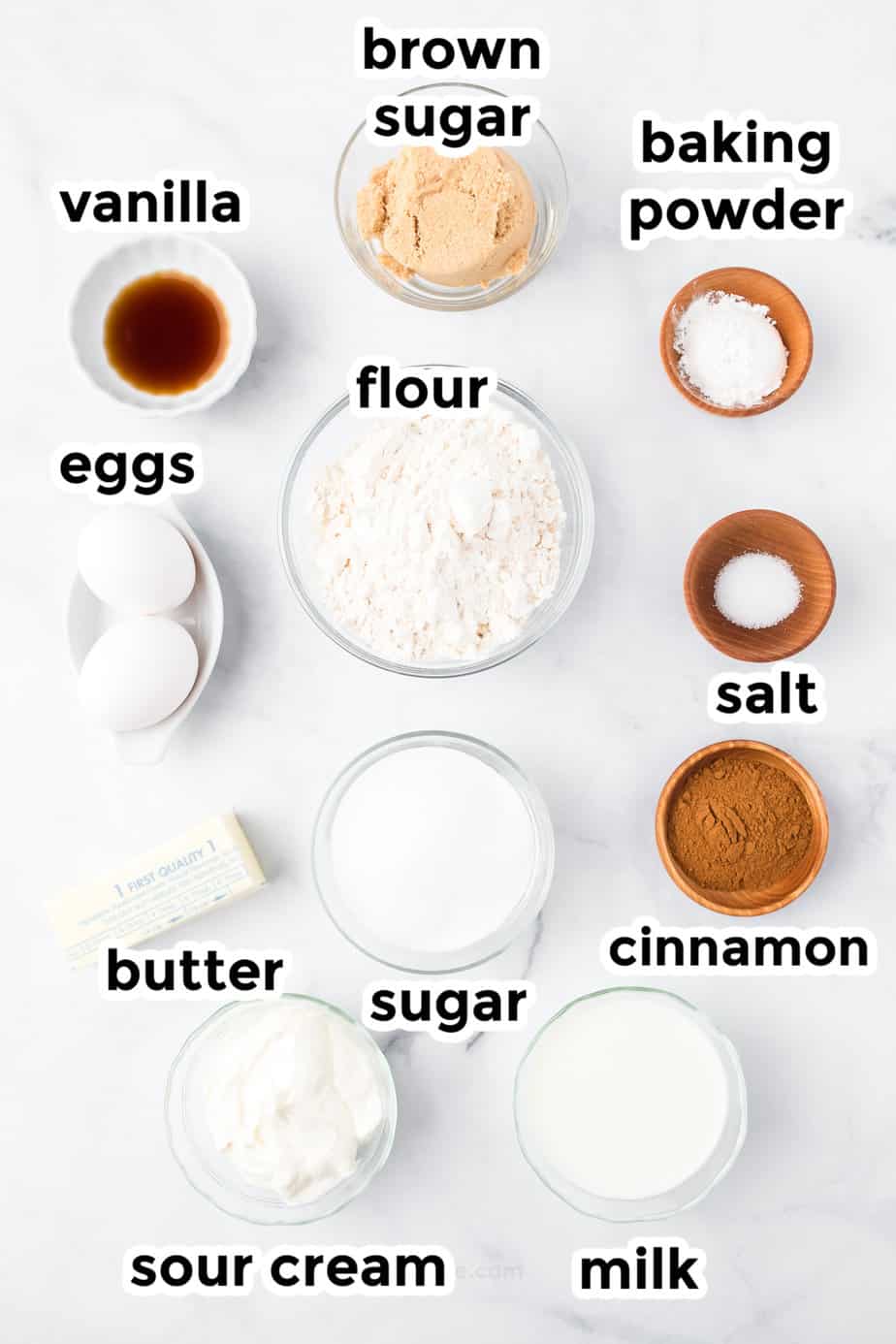 Snickerdoodle bread ingredients in bowls on a counter with text labels.