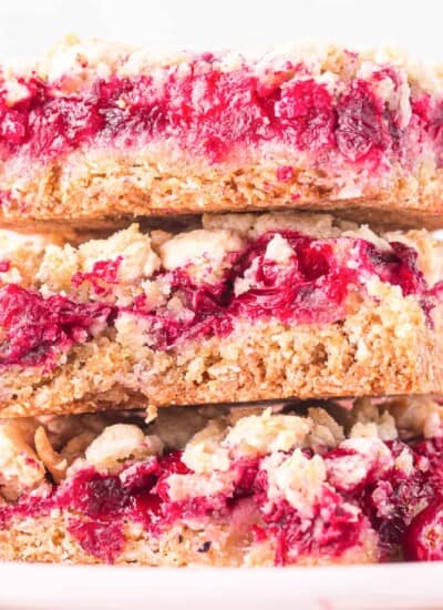 Stacked cranberry bars three high really close up from the side.