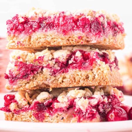 Stacked cranberry bars three high really close up from the side.