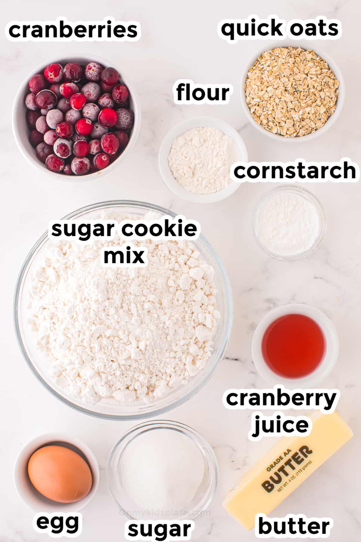 Ingredients for cranberry crumble bars in bowls on a counter from overhead with title text overlay.
