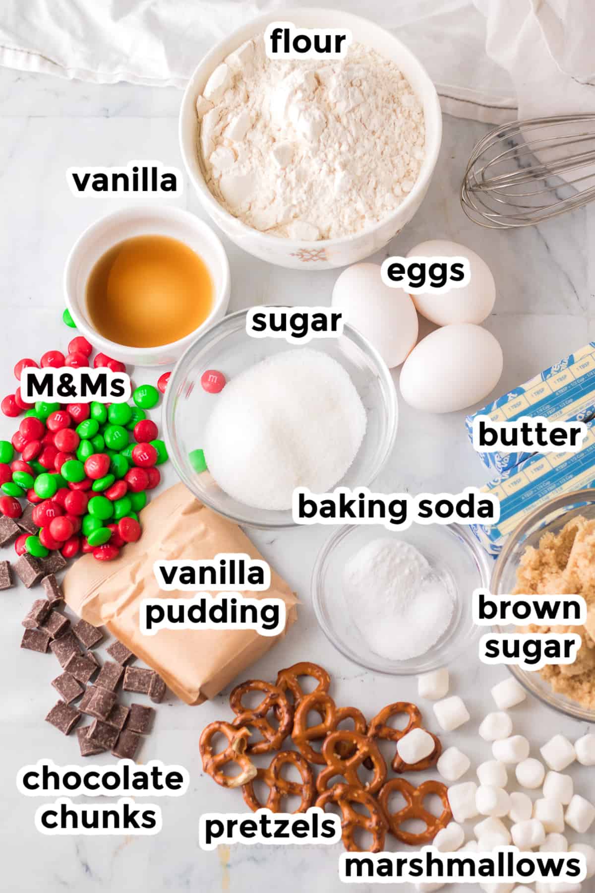 Ingredients for cookies in bowls and set on a counter with text labels from overhead.