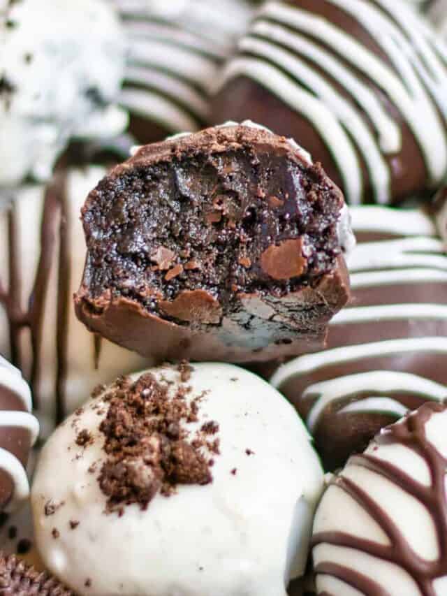 Close up on an Oreo ball with a gooey bite missing on top of other Oreo balls.