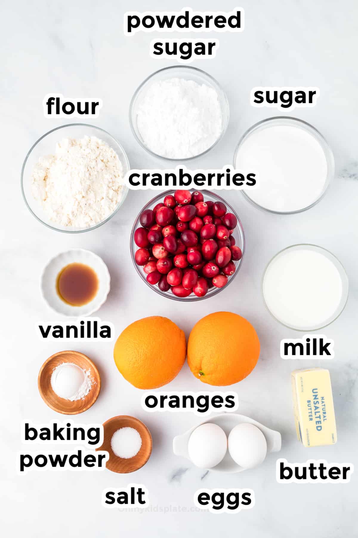 Cranberry Orange bread ingredients in bowls on a counter from overhead with ingredient text labels.