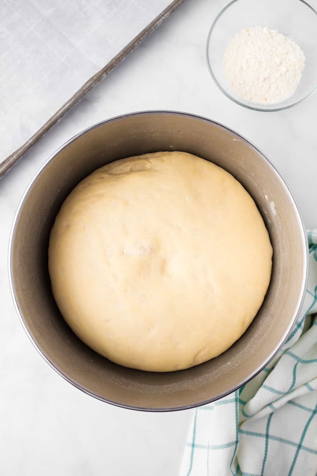 Garlic knot dough in a large mixing bowl from overhead after rising.